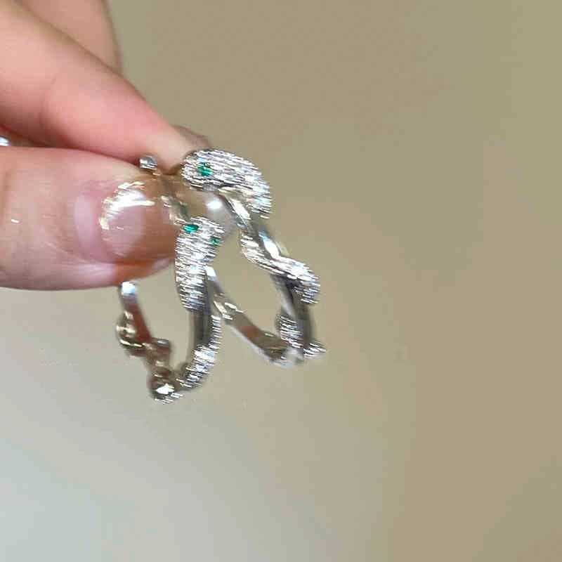 Silver Twisted Branch Green Crystal Clip-on Earring — front view