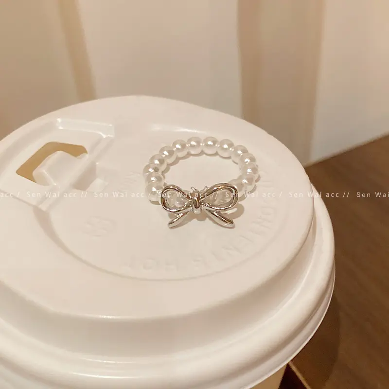 Silver Bow Knot Pearl Stretch Ring — front view